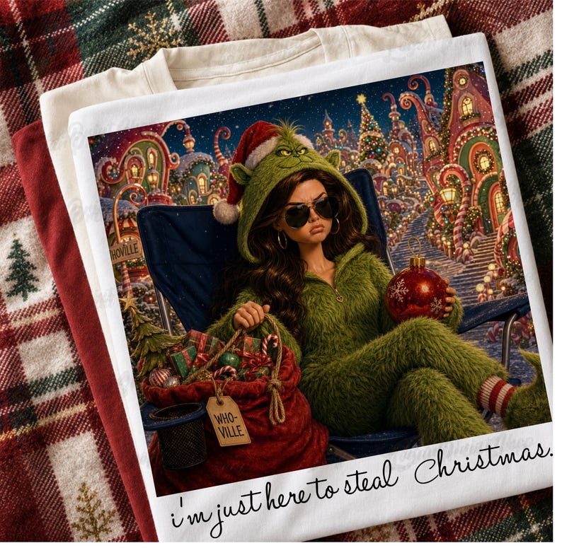 May include: A white t-shirt featuring a graphic of a person in a green fuzzy hooded outfit and sunglasses sitting in a chair, holding a red ornament next to a red sack labeled "WHO-VILLE". The text "i'm just here to steal Christmas" is printed below.