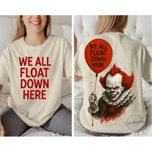 May include: Cream-colored t-shirt with the text "WE ALL FLOAT DOWN HERE" in red. The back of the shirt features a red balloon and a graphic of a clown with red hair and a ruffled collar.