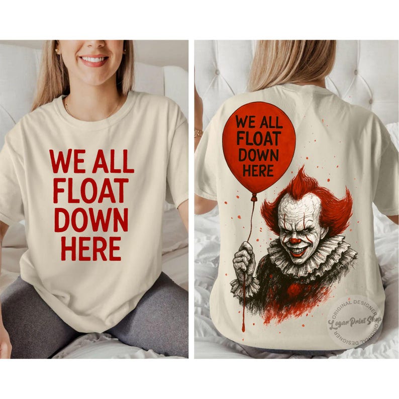 May include: Cream-colored t-shirt with the text "WE ALL FLOAT DOWN HERE" in red. The back of the shirt features a red balloon and a graphic of a clown with red hair and a ruffled collar.