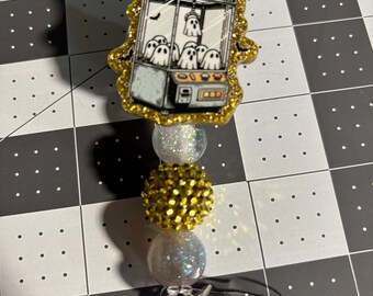 Ghost in claw machine badge reel