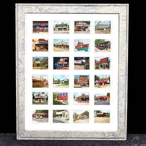 May include: A framed artwork featuring a grid of 24 small, colorful paintings of vintage roadside businesses. The frame is a light color with a speckled pattern. The frame measures 18.5 x 22.5 inches.