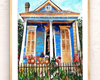 May include: An art print of a blue house with orange trim, white columns, and brown shutters. Colorful flowers sit in pots along a black fence. The artwork is framed in a light wood frame. The text "Don Gould Art" is visible.