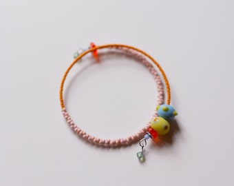 satellite bangle--tangerine/pink--a vintage glass beaded bracelet by budpnq