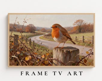May include: A landscape painting featuring a robin with a bright orange breast perched on a wooden fence post. The scene includes a winding dirt path, a wooden fence, and autumn trees in the background. The text FRAME TV ART is printed below.