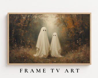 May include: A rectangular framed wall art piece featuring a painting of two figures draped in white sheets standing in an autumn forest with brown and orange foliage. The text FRAME TV ART is printed in black below the wooden frame.