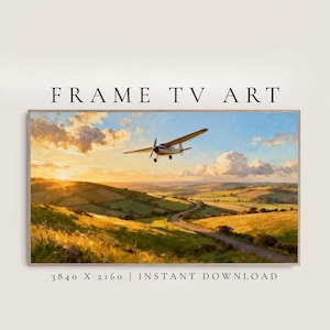 May include: A framed landscape art print featuring a small airplane soaring over rolling green hills and a winding road. The sky is filled with a vibrant sunset, with the text "FRAME TV ART" at the top and "3840 X 2160 | INSTANT DOWNLOAD" at the bottom.