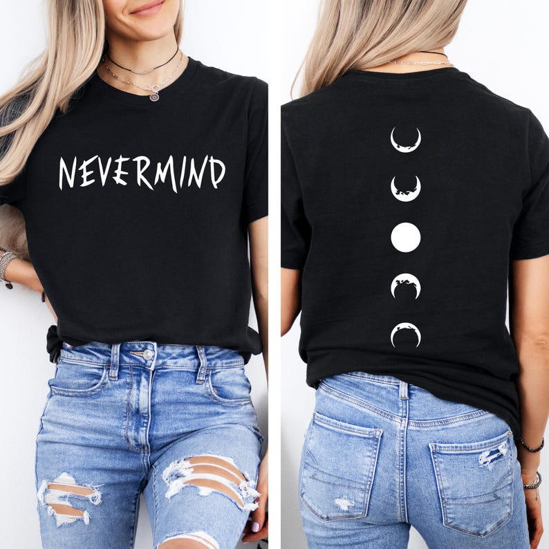 May include: Black t-shirt with the white text "NEVERMIND" on the front. The back of the shirt features a vertical line of white moon phase graphics. The shirt is paired with blue denim jeans.