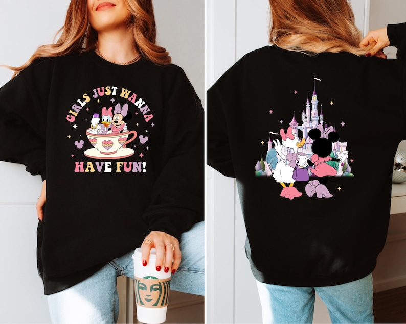May include: Black sweatshirt with a graphic print of Mickey Mouse and Minnie Mouse in a teacup with the text "Girls Just Wanna Have Fun!" on the front and a graphic print of Mickey Mouse and Minnie Mouse in front of a castle on the back.