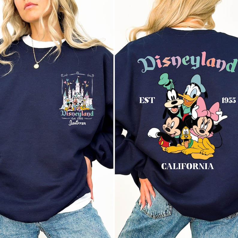 May include: A navy blue sweatshirt with a graphic print of Disneyland's castle and the text "Disneyland est 1955 Jennifer". The back of the sweatshirt has a graphic print of Mickey Mouse, Minnie Mouse, Goofy, Donald Duck, and Pluto with the text "Disneyland est 1955 California".