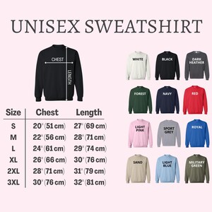 Peut inclure: Image pr&eacute;sentant des sweatshirts unisexes de diff&eacute;rentes couleurs, dont blanc, noir et rouge. L'image comprend un tableau des tailles avec des mesures de poitrine et de longueur en centim&egrave;tres. Le texte "UNISEX SWEATSHIRT" est en haut.