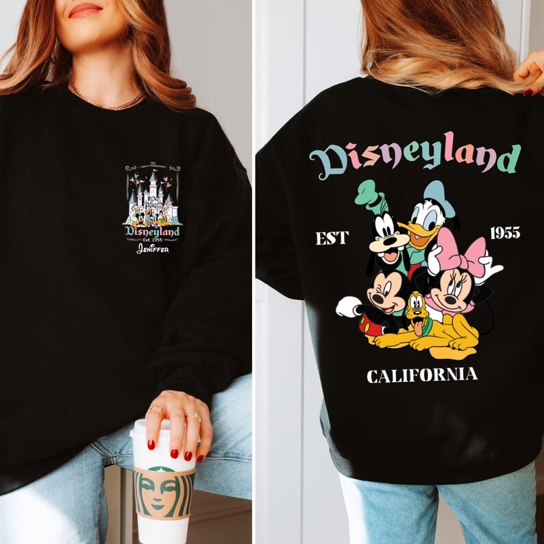 May include: Black sweatshirt with a graphic print of Disneyland's castle and the text "Disneyland est. 1955 Jennifer". The other side of the sweatshirt has a graphic print of Mickey Mouse, Minnie Mouse, Goofy, Pluto, and Donald Duck with the text "Disneyland est. 1955 California".