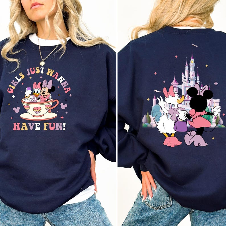 May include: A navy blue sweatshirt with a graphic of Mickey Mouse and Minnie Mouse in a teacup on the front. The back of the sweatshirt features a graphic of a castle and Daisy Duck and Minnie Mouse.