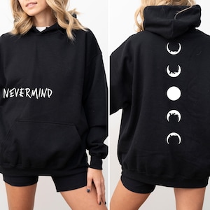 May include: Black hoodie with the word "NEVERMIND" in white script on the front. The back of the hoodie features a vertical design of white moon phases. The hoodie has a front pocket and a hood.