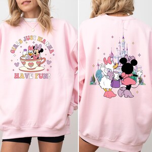 May include: Pink sweatshirt with a graphic of Mickey Mouse and Minnie Mouse in a teacup with the text "Girls Just Wanna Have Fun!"