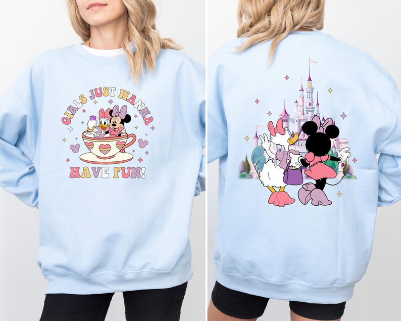 May include: Light blue sweatshirt with a graphic of Mickey Mouse and Minnie Mouse characters in a teacup. The text "Girls Just Wanna Have Fun!" is printed on the front of the sweatshirt.