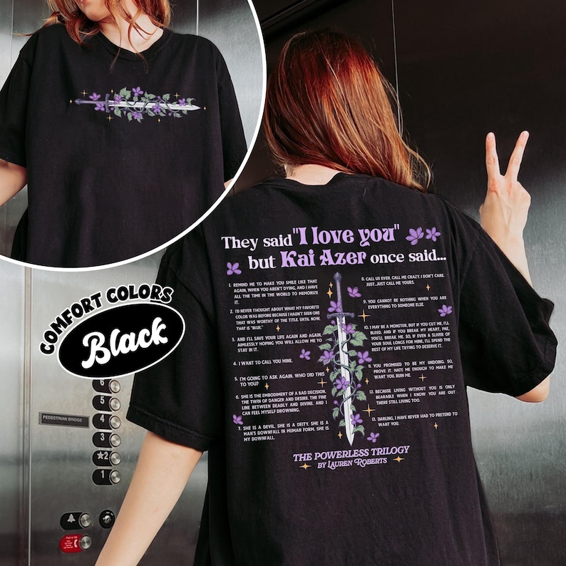 May include: Black t-shirt with a floral and sword design on the front and back. The back of the shirt features text that reads "They said 'I love you' but Kai Azer once said..." and a list of quotes. The shirt is labeled "Comfort Colors."