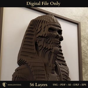 May include: A brown, layered relief sculpture of a pharaoh's profile, framed in a dark brown border. The artwork is composed of 56 layers and is labeled "Digital File Only." The image also includes the text "MANILENYOSVG" and file type options: SVG, PDF, AI, DXF, and EPS.