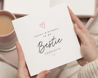 May include: A white card with pink hearts and black text that reads "Happy Birthday to my Bestie Charlotte".