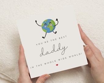 May include: A square greeting card with the text "YOU'RE THE BEST daddy IN THE WHOLE WIDE WORLD!" and a small red heart. The card features a cartoon Earth with arms and legs. The Earth is blue and green with a smiling face.