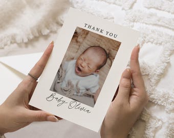 May include: A white thank you card with a photo of a baby girl with the text "Thank You" and "Baby Olivia" in black.