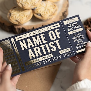 May include: A navy blue ticket with gold detailing, printed with "NAME OF ARTIST" and event information. The ticket is personalized for "Gracie Williams" with a message from "Mum & D". The event is on Sunday 7th July 2027, at 2:00 PM in Hyde Park, London.