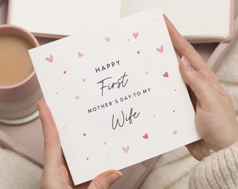 May include: A white card with pink hearts and the text "Happy First Mother's Day to my Wife".