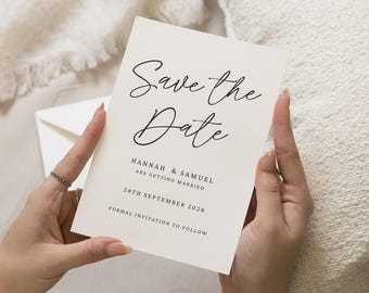 May include: A cream-colored "Save the Date" card held by hands. The card features elegant black script that reads "Save the Date" and details for Hannah & Samuel's wedding on September 28, 2028. The text "Formal invitation to follow" is also included.