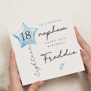May include: A birthday card with the text "To a special nephew" and "Happy 18th Birthday Freddie". The card features a blue star-shaped balloon with the number 18 inside and two small blue hearts.