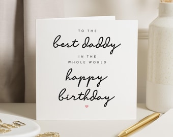 May include: White card with black text that reads "To the best daddy in the whole world happy birthday" with a small pink heart at the bottom.