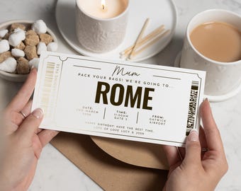 以下が含まれることがあります： 大きな文字で「ROME」と書かれたクリーム色の搭乗券。テキストには「お母さん、荷造りして！私たちは…」と書かれており、日付、時間、空港の詳細が含まれています。搭乗券は紅茶のカップと火のついたろうそくの近くにあります。