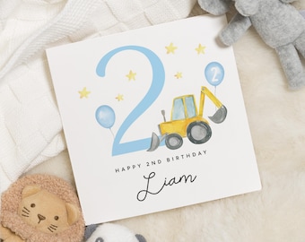 May include: A blue and yellow birthday card featuring a number 2, a yellow construction vehicle, and blue balloons. The card reads "Happy 2nd Birthday Liam".