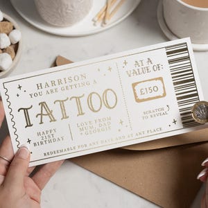 Buono tatuaggio, biglietto tatuaggio, buono regalo tatuaggio, biglietto gratta e vinci tatuaggio, rivelazione tatuaggio, tatuaggio a sorpresa, buono regalo tatuaggio di Natale