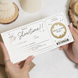 Könnte beinhalten: Ein cremefarbenes Ticket mit goldfarbenen Akzenten, das von einer Person gehalten wird. Auf dem Ticket steht "It's Showtime!" und enthält Details wie Datum, Uhrzeit und Ort. Ein Rubbelbereich ist vorhanden, mit den Worten "Show Name Here".