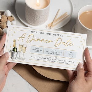 May include: A Dinner Date gift card with gold detailing, showing a champagne bottle in an ice bucket and two champagne flutes. The card reads "Just for You, Oliver" and includes date and time details.