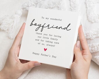 May include: A white card with the text "To my wonderful boyfriend" in a handwritten font. The card also includes the message "thank you for loving our little family and for taking care of us, always!" and "Happy Father's Day" with a small red heart.