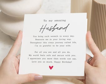 May include: A white greeting card with the text "To my amazing Husband" in elegant script. The card includes a heartfelt message and a small red heart. The card is a birthday gift.