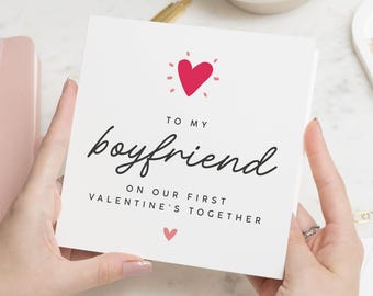 May include: A white card with a red heart and the text "To my boyfriend on our first Valentine's together".