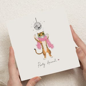May include: A square greeting card featuring an illustration of an orange and black tiger wearing star-shaped sunglasses and a pink feather boa. Above the tiger is a disco ball, and below is the text Party Animal with a small pink heart.