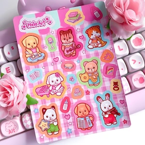 May include: A sheet of colorful stickers featuring cartoon animals playing musical instruments. The stickers include a dog playing a keyboard, a bear with a drum, and a bunny with a violin. The stickers are on a pink and white checkered background with the text "Holo Art".
