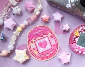 Tamagotchi Pix roze holografische sticker met virtueel huisdierthema voor tijdschrift IPad-decor