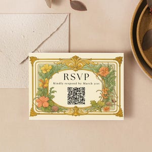 May include: An invitation suite featuring an RSVP card with floral and gold accents, a QR code, and the text "RSVP." The suite includes a matching envelope and decorative plates with dried flowers and leaves. The color palette is neutral with warm tones.
