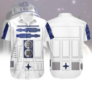 May include: White button-down shirt featuring a design inspired by the Star Wars character R2-D2. The shirt has blue and gray accents, with a detailed graphic on the front and back. The design includes rectangular and circular shapes.