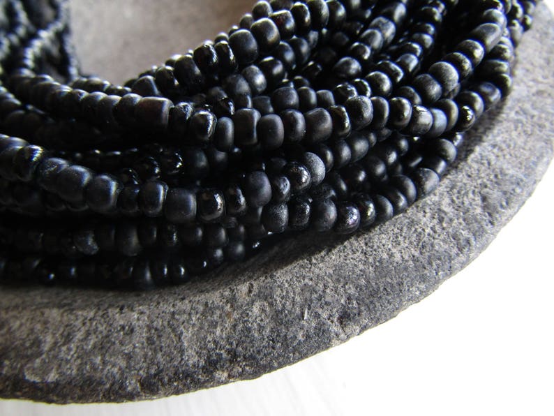 irregular organic tube barrel spacer Indonesia 3mm to 5mm dia small matte glossy black 44 inch strand 20ab1-10 black seed glass beads
