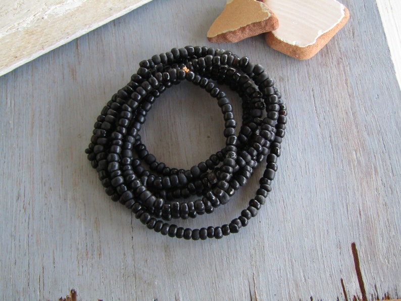 irregular organic tube barrel spacer Indonesia 3mm to 5mm dia small matte glossy black 44 inch strand 20ab1-10 black seed glass beads