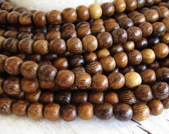 Robles brown round  wood beads,  finished,   5mm to 6mm  diameter ( 15 inches strand) 20ab34