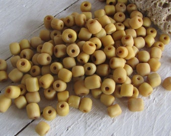 muted yellow glass seed bead,  spacer , indonesian 4.5 to 5.5mm dia, new indo-pacific (35 grams ) 22ab14-20b