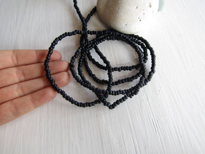 irregular organic tube barrel spacer Indonesia 3mm to 5mm dia small matte glossy black 44 inch strand 20ab1-10 black seed glass beads