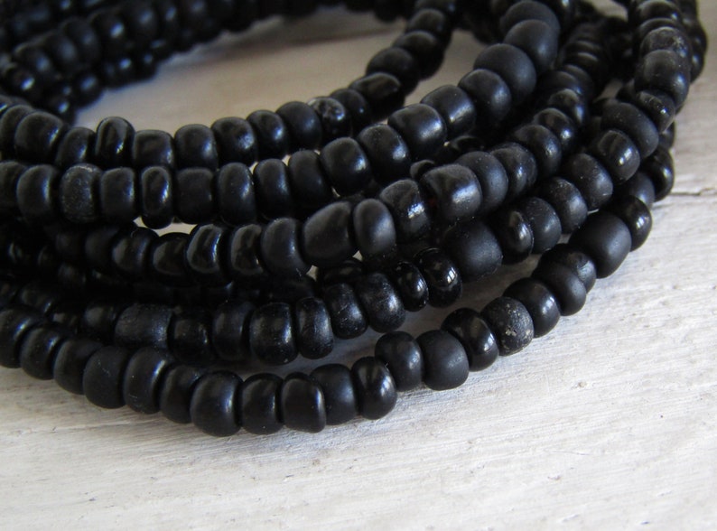 irregular organic tube barrel spacer Indonesia 3mm to 5mm dia small matte glossy black 44 inch strand 20ab1-10 black seed glass beads