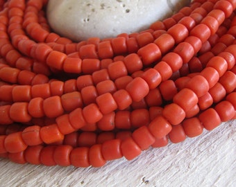 red  orange glass seed bead, matte barrel tube, small  ethnic spacer , indonesian 4.5 to 6.5mm dia, new indo-pacific (22 inches) 22ab14-7