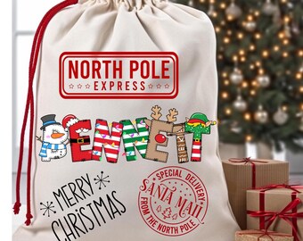 May include: A white canvas Santa sack with red drawstring, featuring a red and white striped design with the words "NORTH POLE EXPRESS" and "MERRY CHRISTMAS". The sack also has a red stamp with the words "SPECIAL DELIVERY SANTA MAIL FROM THE NORTH POLE".